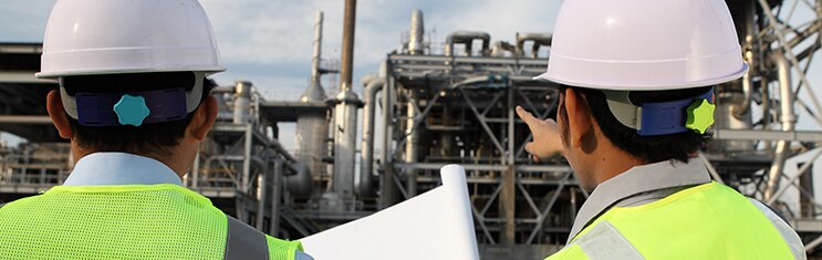 two engineer oil industry discussing a new project with large oil refinery background; Shutterstock ID 103254842; PO: redownload; Job: redownload; Client: redownload; Other: redownload